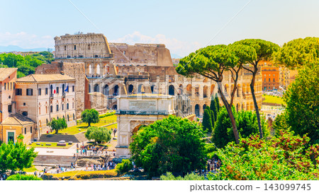 Visitors walk through the Roman Forum and view the Colosseum under a clear sky. These historical sites draw many tourists and showcase ancient Roman architecture and culture. Visitors walk through the Roman Forum and view the Colosseum under a clear sky. These historical sites draw many tourists and showcase ancient Roman architecture and culture. 143099745