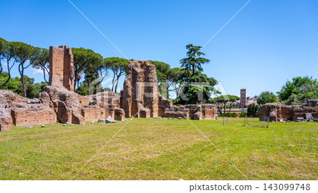 Visitors walk through the Roman Forum ruins in Rome Italy. These ancient remains show the history and structure of an important site from the Roman Empire era. Visitors walk through the Roman Forum ruins in Rome Italy. These ancient remains show the history and structure of an important site from the Roman Empire era. 143099748
