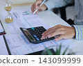 Businessman Calculating Financial Budget with Hourglass Clock on Desk. Time Management Concept. 143099999