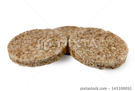 Three round whole grain rice cakes on a white background 143100091