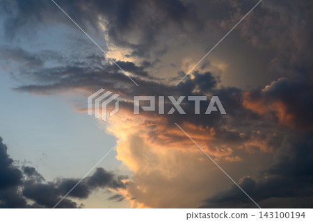 Dramatic sunset landscape featuring heavy storm clouds and brilliant golden illumination Dramatic sunset landscape featuring heavy storm clouds and brilliant golden illumination 143100194