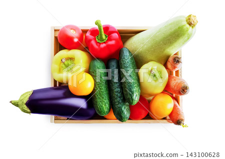 Fresh organic vegetable harvest in a wooden crate with tomato, pepper, cucumber, eggplant, carrot, and zucchini. Raw garden produce isolated on white background with shadow. Fresh organic vegetable harvest in a wooden crate with tomato, pepper, cucumber, eggplant, carrot, and zucchini. Raw garden produce isolated on white background with shadow. 143100628