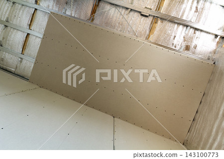 Room under construction with silver aluminum insulation foil and drywall on walls and ceiling. Room under construction with silver aluminum insulation foil and drywall on walls and ceiling. 143100773