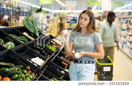 Cheerful woman choosing mushrooms Cheerful woman choosing mushrooms 143101689