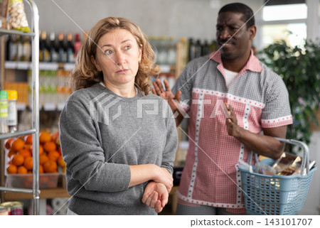 European wife and African husband, yells at each other in shop European wife and African husband, yells at each other in shop 143101707