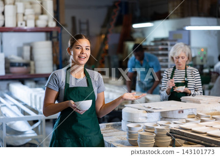 Female sculptor having ceramics in hands and standing in workroom Female sculptor having ceramics in hands and standing in workroom 143101773