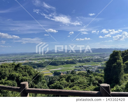 Rice fields and mountain ranges viewed from a hilltop in Yamaga City, Kumamoto Prefecture. 143102420