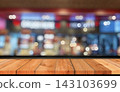 perspective wooden board over bokeh shop background 143103699