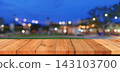 Empty wooden table top with blurred festive bokeh lights at night market 143103700