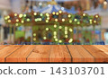 wooden board over bokeh carousel in fun park 143103701