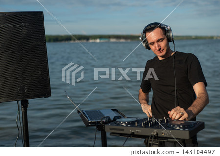 Portrait of a DJ on the river bank. Portrait of a DJ on the river bank. 143104497