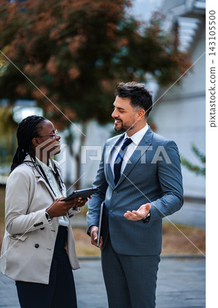 Diverse business professionals having informal meeting outdoors Diverse business professionals having informal meeting outdoors 143105500