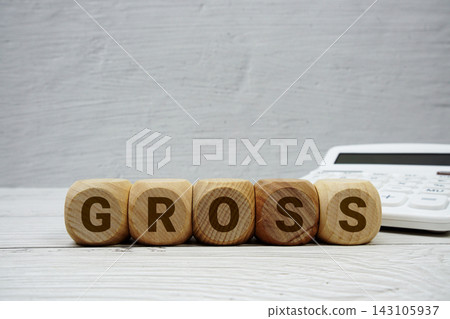 GROSS alphabet letters with calculator on wooden background GROSS alphabet letters with calculator on wooden background 143105937