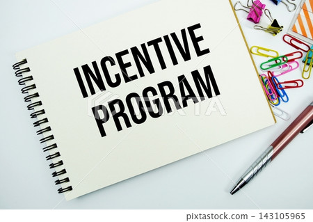 Incentive program text message written on notepad with stationery flat lay on white background Incentive program text message written on notepad with stationery flat lay on white background 143105965