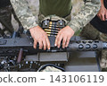 Soldier Loading Ammunition Belt Into Heavy Machine Gun 143106119