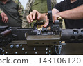 Soldier Loading Ammunition Belt Into Heavy Machine Gun 143106120