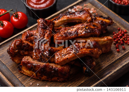 Grilled pork or beef ribs seasoned with salt and spices, served in sauce. Grilled ribs Grilled pork or beef ribs seasoned with salt and spices, served in sauce. Grilled ribs 143106911