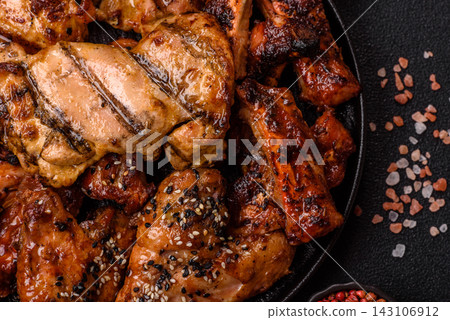 Grilled meat set featuring chicken breast, wings, and ribs seasoned with spices. Grilled meat set Grilled meat set featuring chicken breast, wings, and ribs seasoned with spices. Grilled meat set 143106912