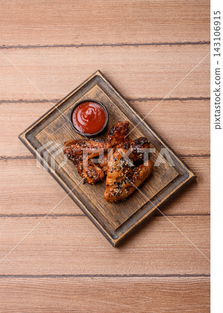 Grilled chicken wings with teriyaki sauce, seasoned with salt and spices. Chicken wings 143106915
