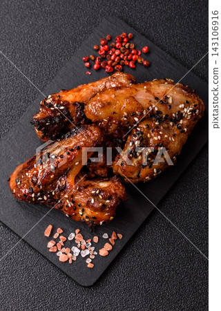 Grilled chicken wings with teriyaki sauce, seasoned with salt and spices. Chicken wings Grilled chicken wings with teriyaki sauce, seasoned with salt and spices. Chicken wings 143106916