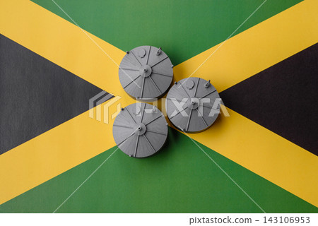 Liquefied gas storage tanks set against the Jamaica flag, concept of supply and distribution Liquefied gas storage tanks set against the Jamaica flag, concept of supply and distribution 143106953