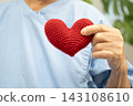 Asian senior patient woman holding red heart for health in hospital. 143108610