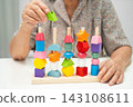Asian elderly woman playing game. 143108611