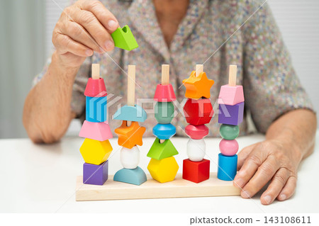 Asian elderly woman playing game. Asian elderly woman playing game. 143108611