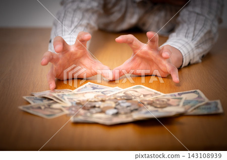 A man reaching for money - dark 143108939