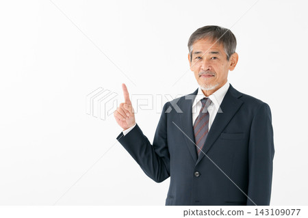 Senior man in a suit, pointing. Senior man in a suit, pointing. 143109077