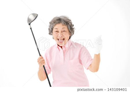 Senior woman holding a golf club; her hobby; posing with her fist pump. Senior woman holding a golf club; her hobby; posing with her fist pump. 143109401