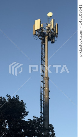 Tall telecommunication tower and 5G cellular antennas against a clear blue sky. Tall telecommunication tower and 5G cellular antennas against a clear blue sky. 143109541