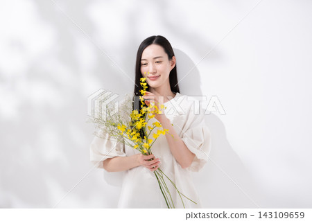手捧花的女子；文心蘭；陽光 143109659