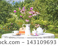 Summer breakfast in the sunny blooming garden 143109693