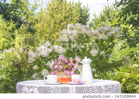 Summer breakfast in the sunny blooming garden Summer breakfast in the sunny blooming garden 143109694