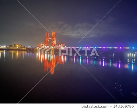 The Chikugo River Lift Bridge is illuminated at night, adding a touch of beauty to the water's surface. The Chikugo River Lift Bridge is illuminated at night, adding a touch of beauty to the water's surface. 143109790