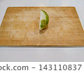 Onion cut in half on a cutting board 143110837
