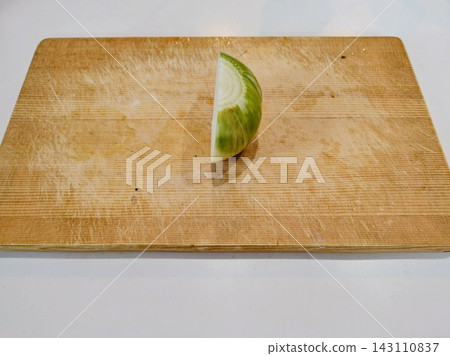 Onion cut in half on a cutting board Onion cut in half on a cutting board 143110837