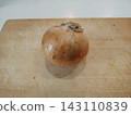 Onions on a cutting board 143110839