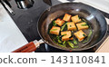 Simmered deep-fried tofu and spinach made in an iron skillet 143110841