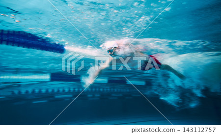 Swimmer moving fast through water with motion blur Swimmer moving fast through water with motion blur 143112757
