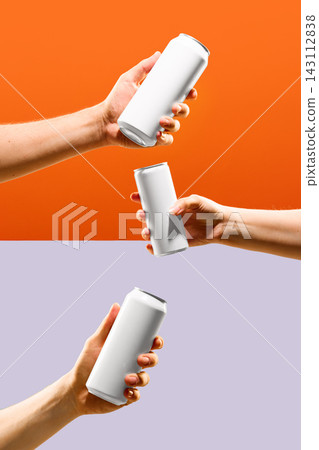 Three blank aluminum cans held by different hands on orange and lavender background with copy space. 143112838