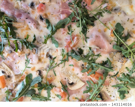 Succulent pizza surface with ham, mushrooms, and arugula Succulent pizza surface with ham, mushrooms, and arugula 143114016