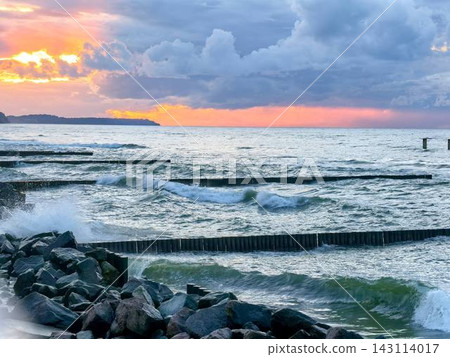 Sunset over the rough Baltic Sea and breakwater Sunset over the rough Baltic Sea and breakwater 143114017