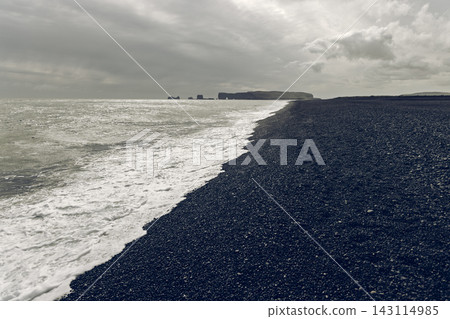 Atlantic Surf Along Reynisfjara Beach with Distant Dyrholaey in Iceland Atlantic Surf Along Reynisfjara Beach with Distant Dyrholaey in Iceland 143114985