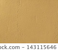 Natural beige stucco wall texture featuring a rough painted surface.  143115646