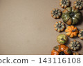 Assorted Decorative Gourds on Brown Background 143116108
