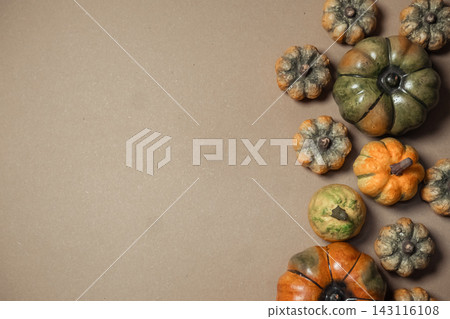 Assorted Decorative Gourds on Brown Background Assorted Decorative Gourds on Brown Background 143116108