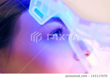 Extreme close up of eye under blue LED mask for skincare therapy. 143117070
