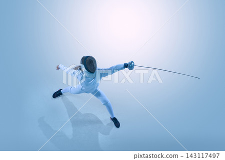 Female fencer attacking with epee from dramatic overhead perspective. 143117497